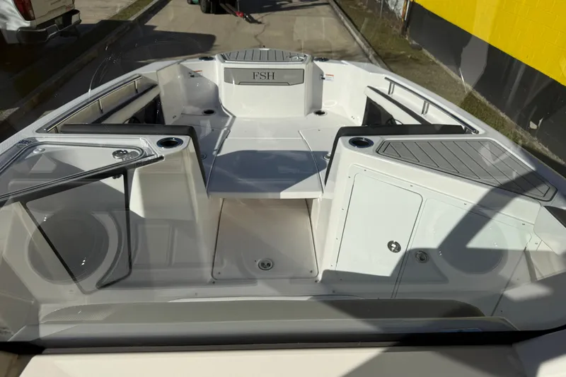 Slide: The Image of 2026 Yamaha Boats 252 FSH Sport interior, showcasing sleek design and spacious seating. - 23