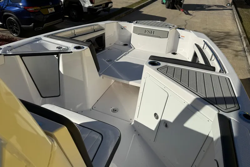 Slide: The Image of 2026 Yamaha Boats 252 FSH Sport interior with seating and storage compartments. - 24