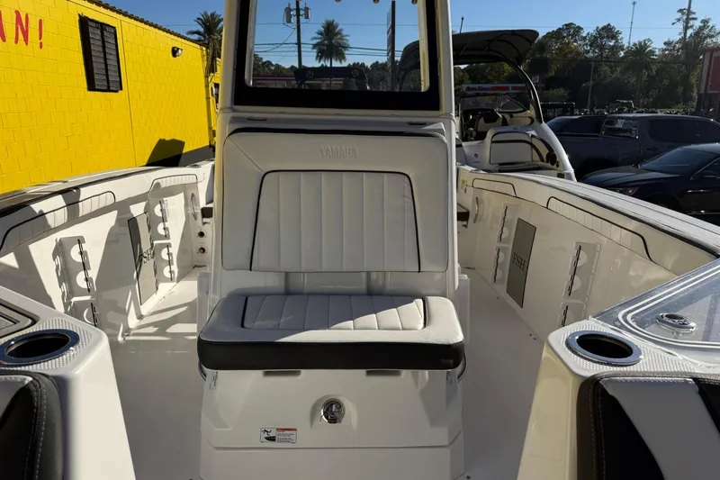 Slide: The Image of 2026 Yamaha Boats 252 FSH Sport interior with white seating and cup holders. - 28