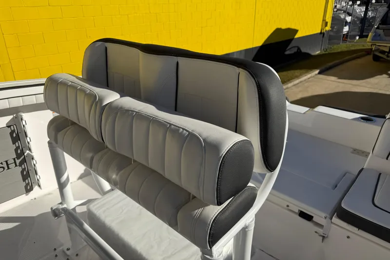 Slide: The Image of 2026 Yamaha Boats 252 FSH Sport seating with cushioned backrest, against a yellow wall. - 39