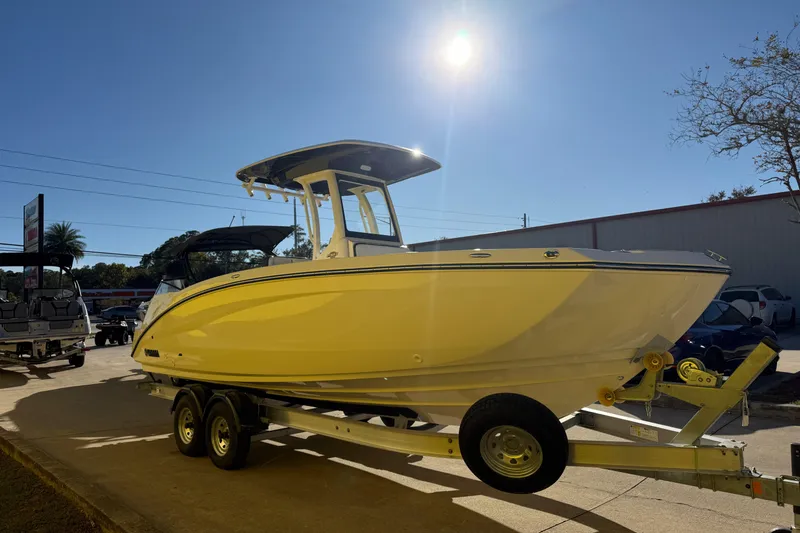 Slide: The Image of 2026 Yamaha Boats 252 FSH Sport on trailer under bright sun. - 8