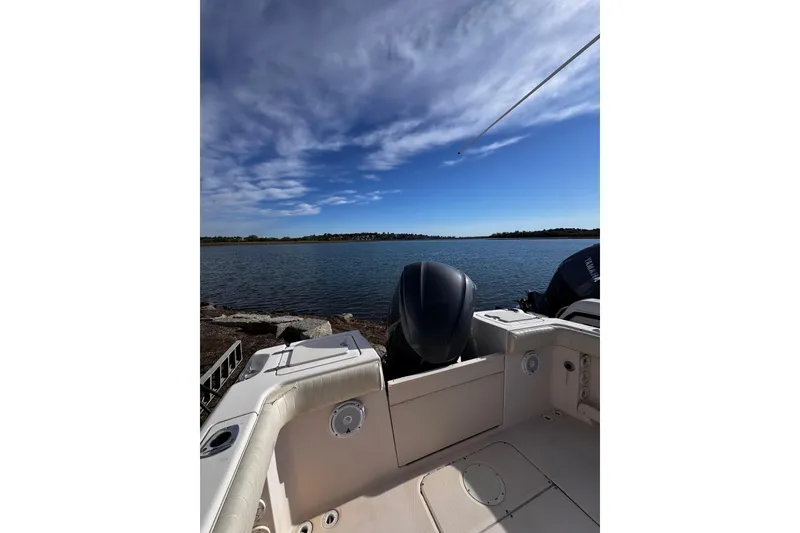 Slide: The Image of 1999 Grady-White Fisherman 222 boat on calm water under a blue sky. - 10