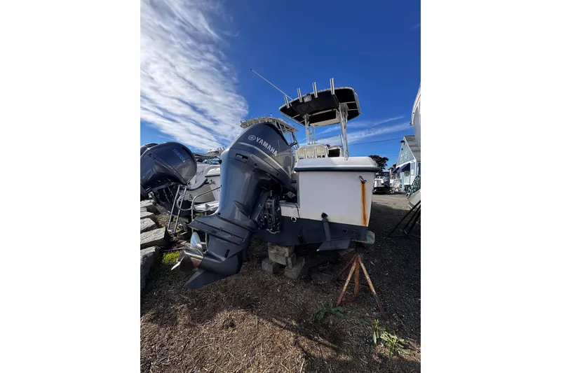 Slide: The Image of 1999 Grady-White Fisherman 222 boat with Yamaha outboard motor, parked on land. - 3