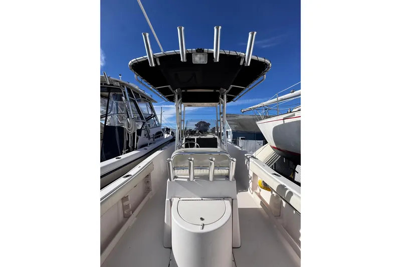 Slide: The Image of 1999 Grady-White Fisherman 222 boat with T-top, docked under clear blue sky. - 4