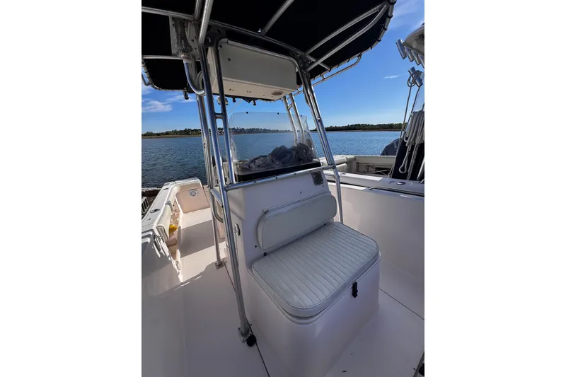 Slide: The Image of 1999 Grady-White Fisherman 222 boat interior with seating, under a clear blue sky. - 6