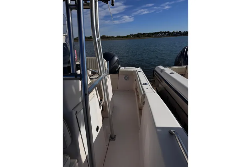 Slide: The Image of 1999 Grady-White Fisherman 222 boat docked on calm water under blue sky. - 8