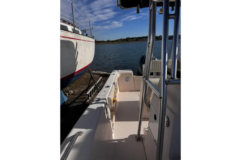 Slide: The Image of 1999 Grady-White Fisherman 222 boat docked by the water under a clear sky. - 9