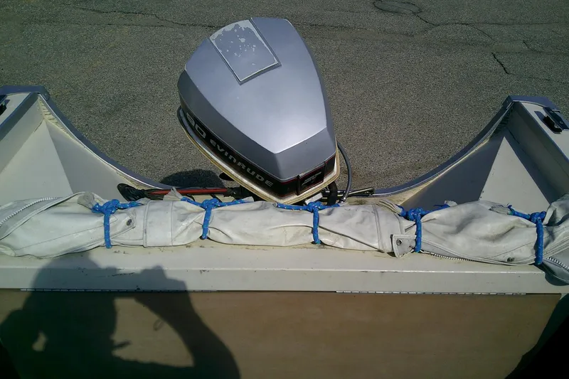 Slide: The Image of 1981 Starcraft SuperSport 160 boat with Evinrude outboard motor, docked on pavement. - 11
