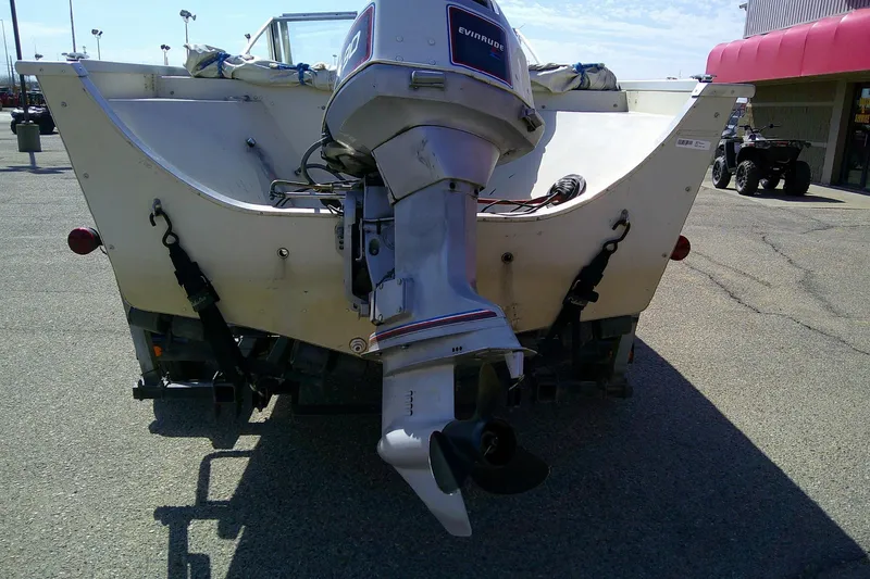 Slide: The Image of 1981 Starcraft SuperSport 160 boat with Evinrude outboard motor, parked outdoors. - 13