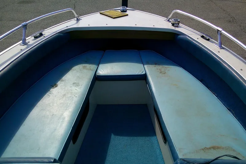 Slide: The Image of Interior of a 1981 Starcraft SuperSport 160 boat with blue seating and carpet. - 8