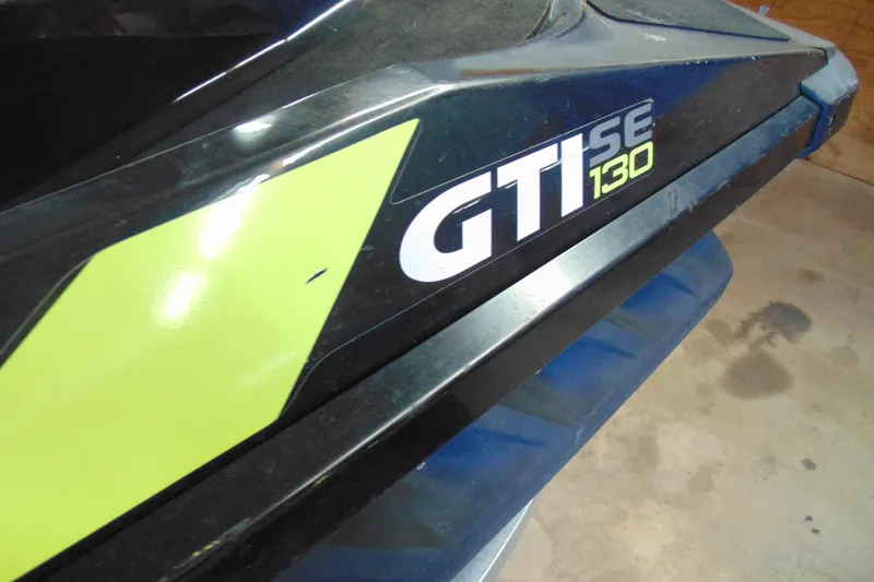 Slide: The Image of 2016 Sea-Doo GTI SE 130 jet ski with distinctive green and black design. - 6