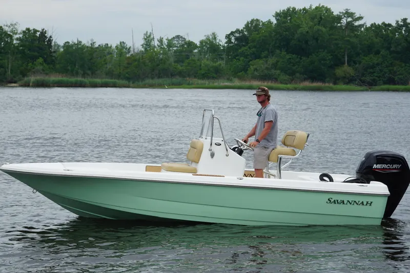Slide: The Image of 2025 Savannah 190 IS boat on water, with driver, featuring Mercury outboard motor. - 4