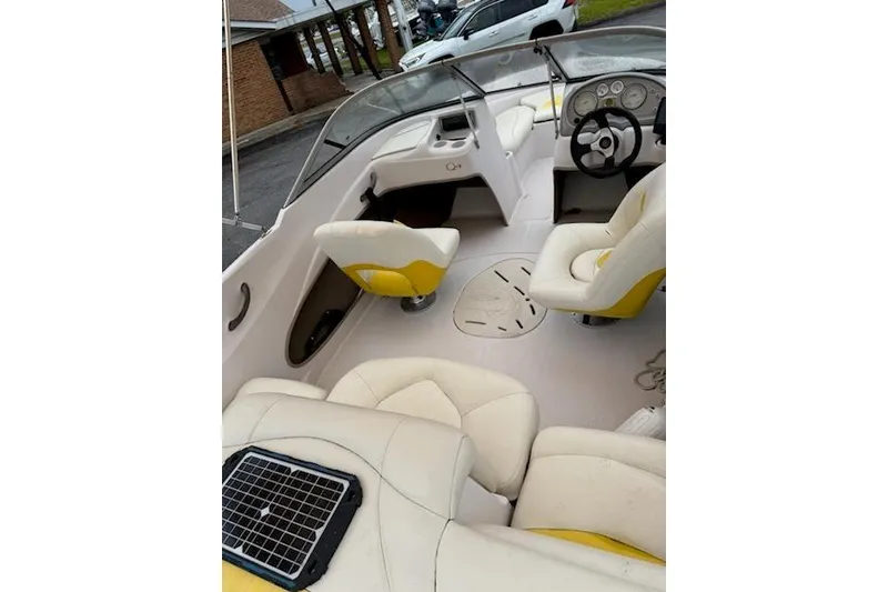 Slide: The Image of Interior of a 2008 Tahoe Q4 SF boat with white and yellow seating. - 5