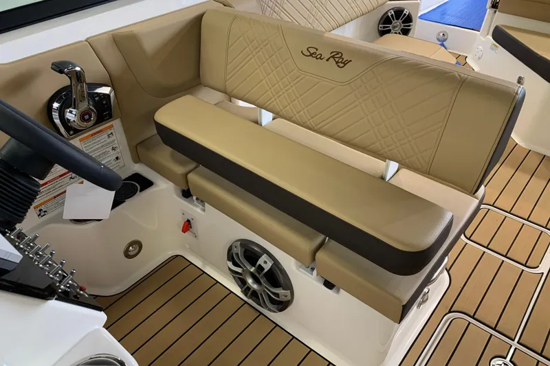 Slide: The Image of 2025 Sea Ray SDX 270 boat interior with tan seating and modern controls. - 12