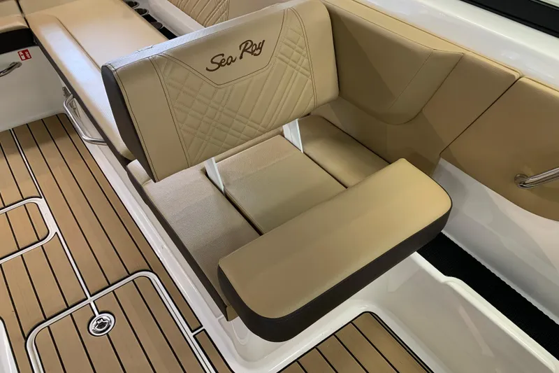 Slide: The Image of Luxurious seating on 2025 Sea Ray SDX 270 boat with tan upholstery and wood-style flooring. - 13