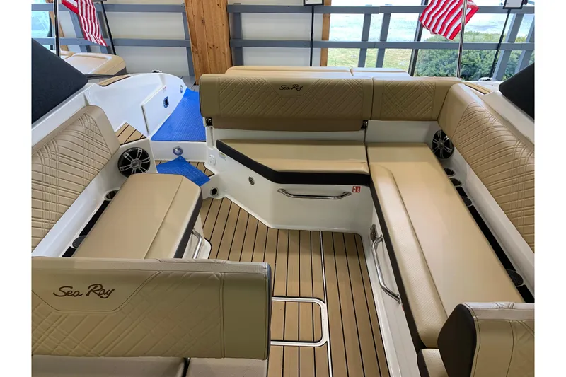 Slide: The Image of Luxurious interior of 2025 Sea Ray SDX 270 boat with tan seating and wood flooring. - 14