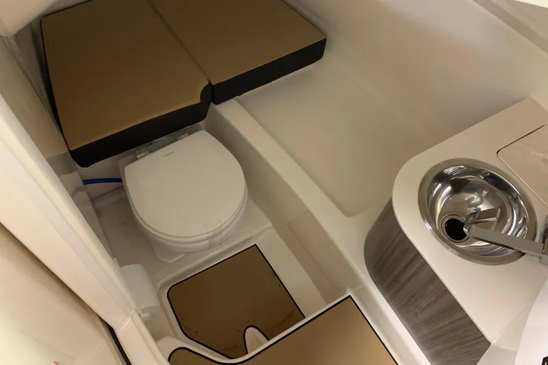 Slide: The Image of 2025 Sea Ray SDX 270 boat interior with toilet and sink. - 15