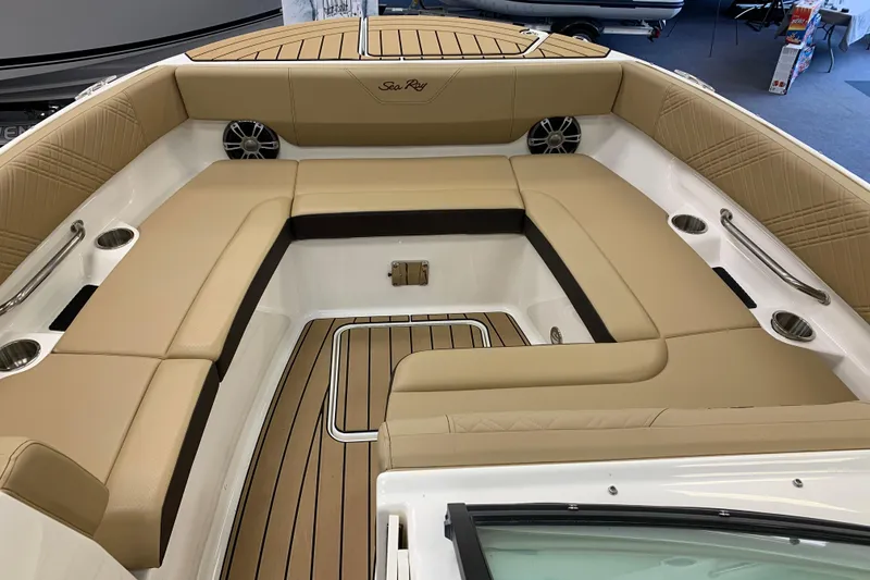 Slide: The Image of Luxurious 2025 Sea Ray SDX 270 boat interior with tan seating and wood accents. - 16