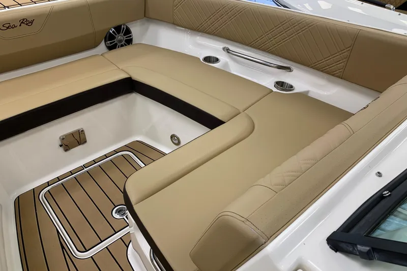 Slide: The Image of 2025 Sea Ray SDX 270 boat interior with tan seating and wood-style flooring. - 17