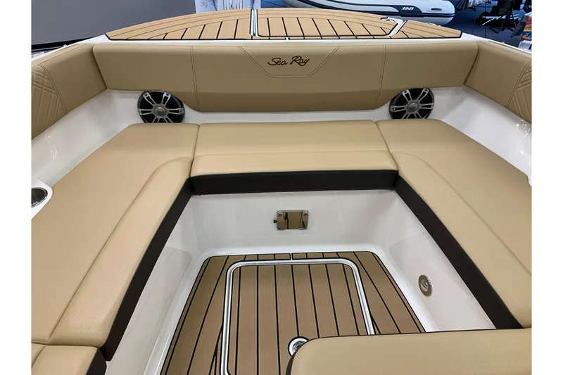 Slide: The Image of 2025 Sea Ray SDX 270 boat interior with tan seating and teak flooring. - 18