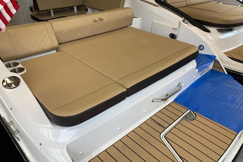 Slide: The Image of 2025 Sea Ray SDX 270 boat interior with tan seating and wood-style flooring. - 20