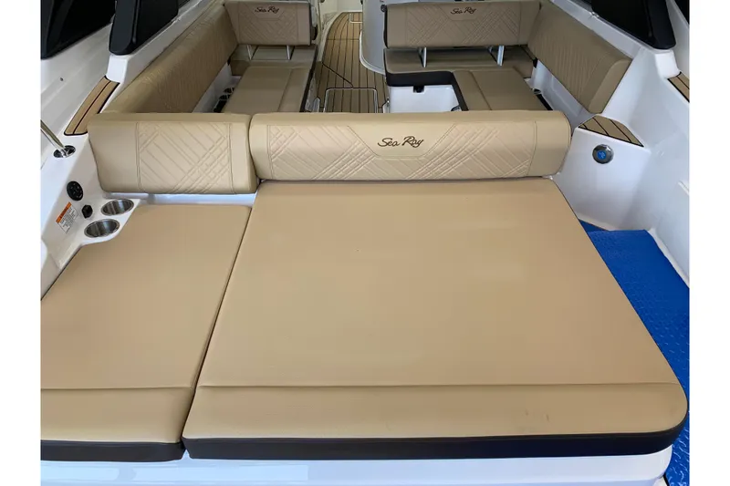 Slide: The Image of 2025 Sea Ray SDX 270 boat interior with beige seating and cup holders. - 4