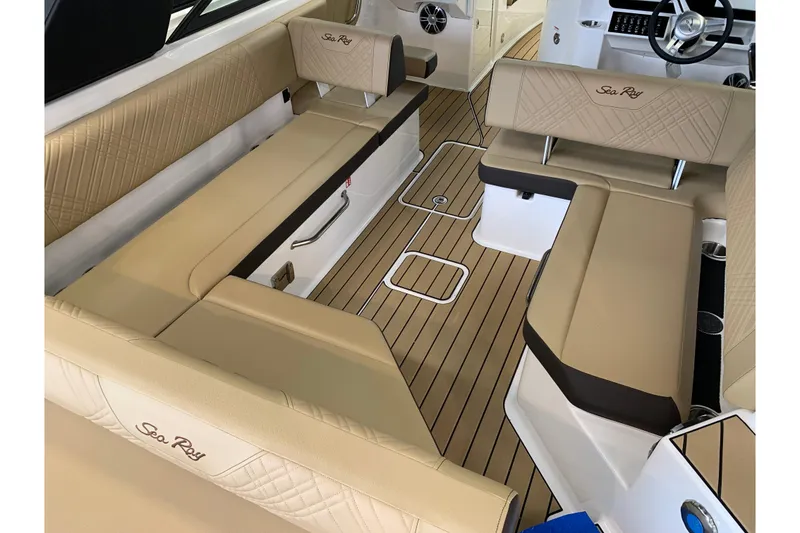 Slide: The Image of Luxurious interior of 2025 Sea Ray SDX 270 boat with beige seating and wood flooring. - 5