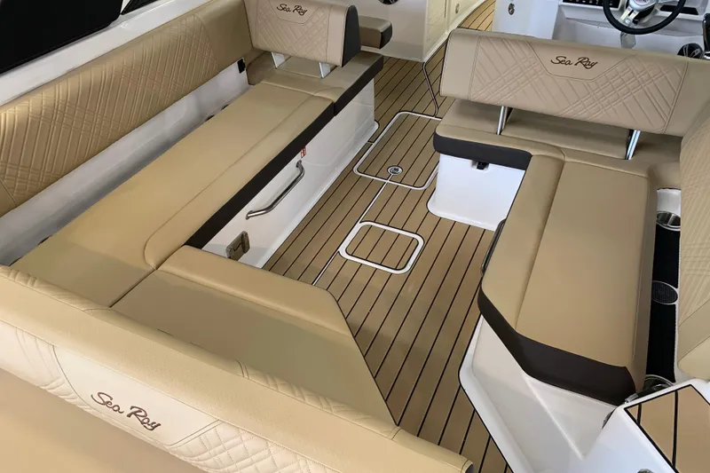 Slide: The Image of Luxurious interior of 2025 Sea Ray SDX 270 boat with beige seating and wood flooring. - 6