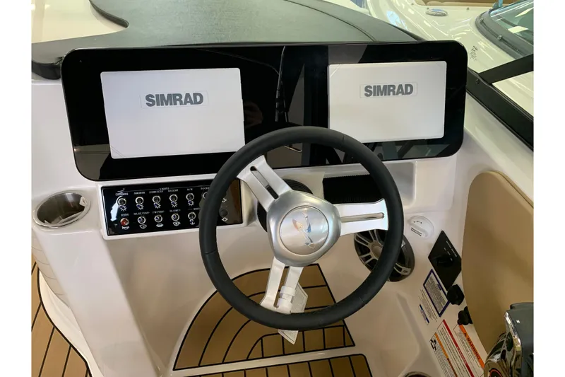 Slide: The Image of 2025 Sea Ray SDX 270 helm with Simrad displays and modern controls. - 9