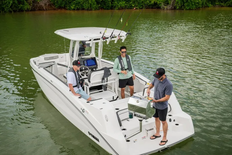 Slide: The Image of 2026 Yamaha Boats 252 FSH Sport on water with three people fishing. - 11