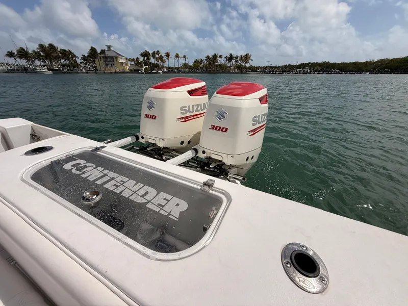 Slide: The Image of Contender 27 Tournament boat with Suzuki 300 engines on the water. - 11