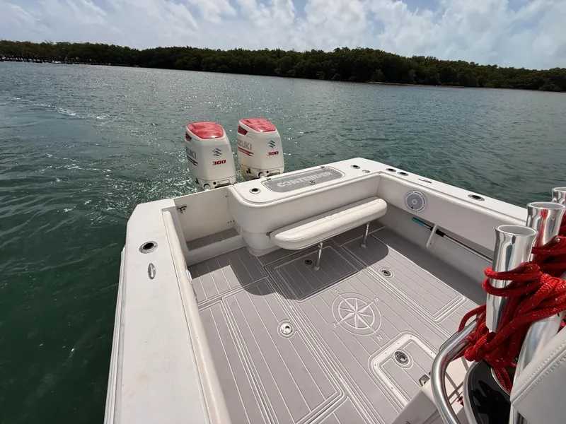 Slide: The Image of Contender 27 Tournament boat from 2001 on calm waters. - 15