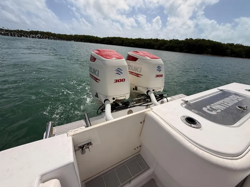 Slide: The Image of Contender 27 Tournament boat with Suzuki 300 engines on the water. - 16