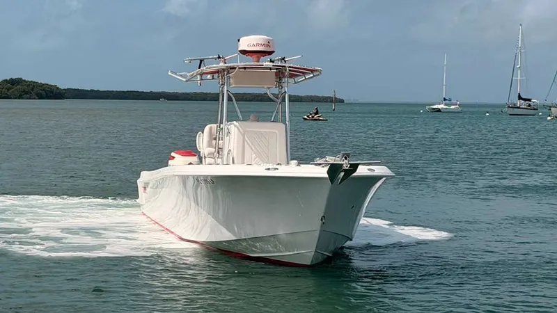Slide: The Image of Contender 27 Tournament boat from 2001 on calm waters. - 2