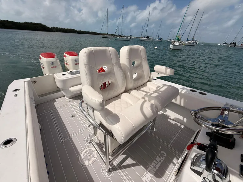 Slide: The Image of Contender 27 Tournament 2001 boat with white seats and Suzuki engines. - 21