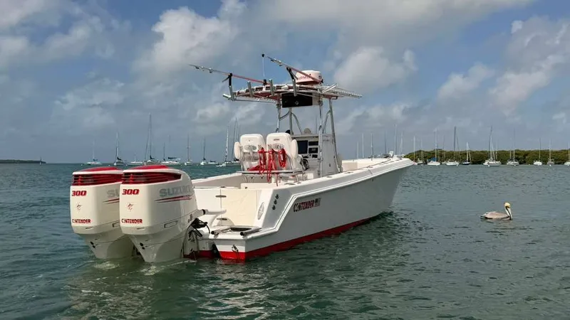 Slide: The Image of 2001 Contender 27 Tournament boat with Suzuki engines on calm water. - 3