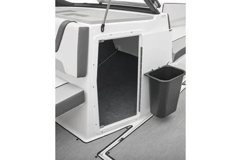 Slide: The Image of 2026 Yamaha Boats AR220 interior storage compartment with open door and trash bin. - 5