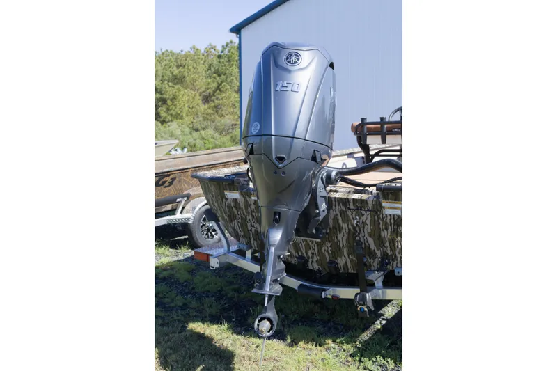 Slide: The Image of Outboard motor on Avid 20 Rogue CC boat, 2026 model, parked outdoors. - 7