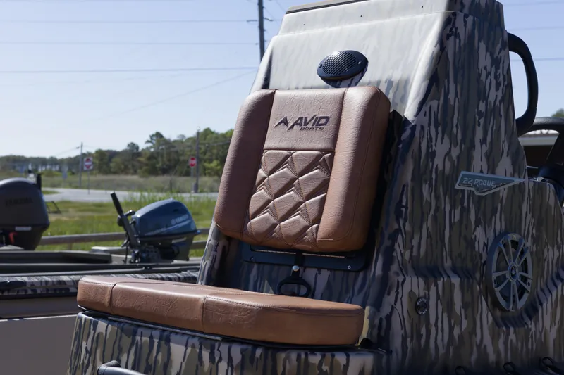 Slide: The Image of Avid 20 Rogue CC 2026 boat seat with camo design and brown leather upholstery. - 9