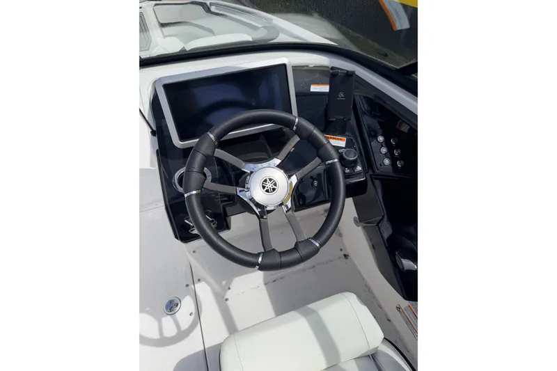 Slide: The Image of 2026 Yamaha Boats 252S steering wheel and dashboard, featuring modern controls and display. - 18