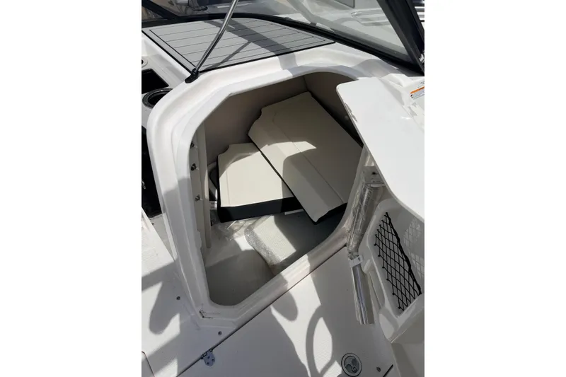 Slide: The Image of 2026 Yamaha Boats 252S storage compartment with seating cushions and netted storage. - 20