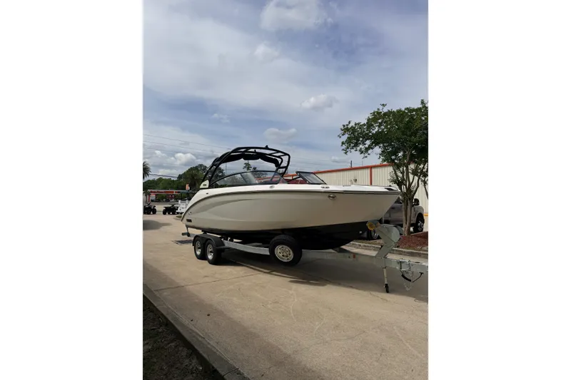 Slide: The Image of 2026 Yamaha Boats 252S on trailer, parked outdoors under cloudy sky. - 5