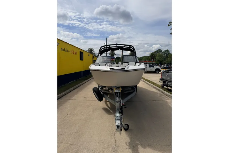 Slide: The Image of 2026 Yamaha Boats 252S on trailer, parked outdoors under cloudy sky. - 6