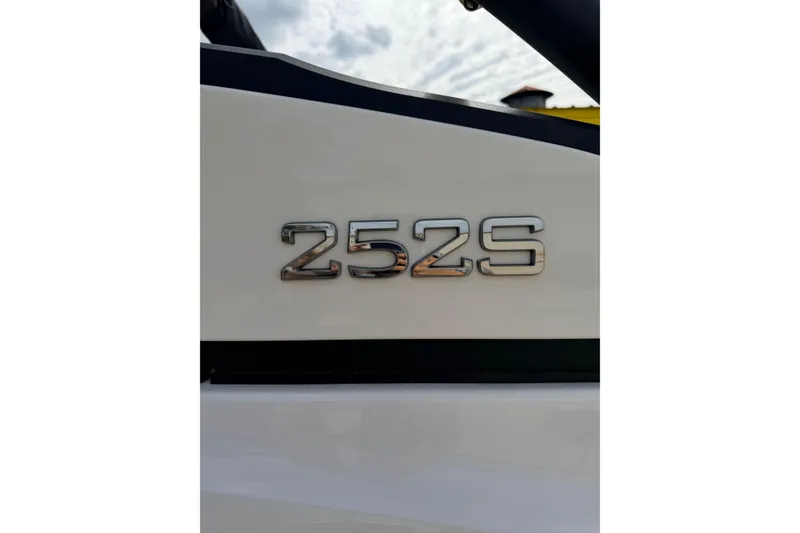 Slide: The Image of Close-up of 2026 Yamaha Boats 252S model emblem on white surface. - 8