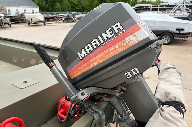 Slide: The Image of 2024 TRACKER MARINE Grizzly 1754 with Mariner 30 outboard motor in a boatyard. - 13