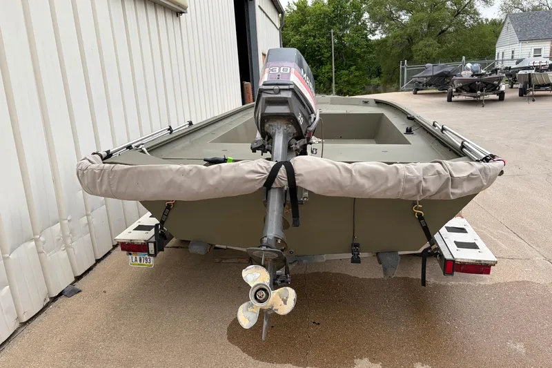 Slide: The Image of 2024 TRACKER MARINE Grizzly 1754 boat with outboard motor, parked outdoors. - 7