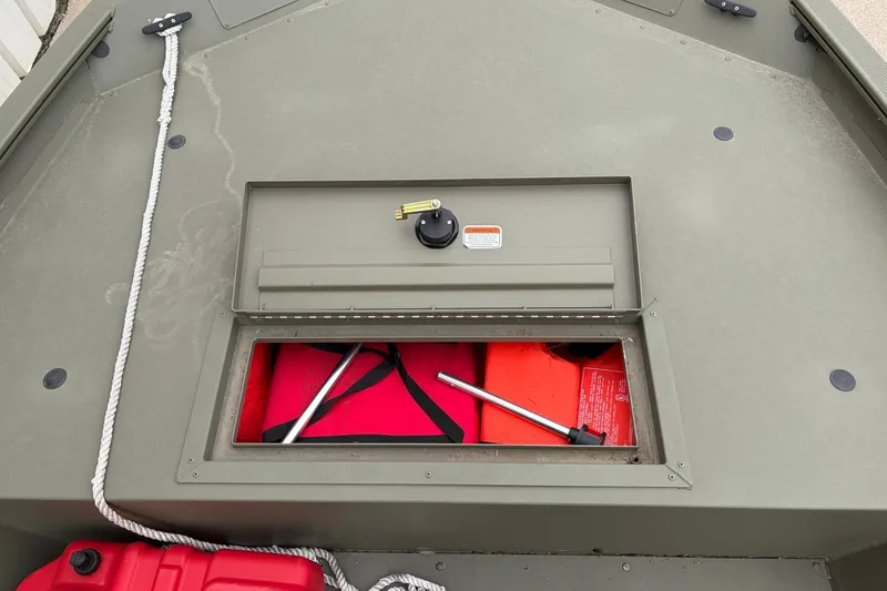 Slide: The Image of 2024 TRACKER MARINE Grizzly 1754 boat storage compartment with safety gear and rope. - 9