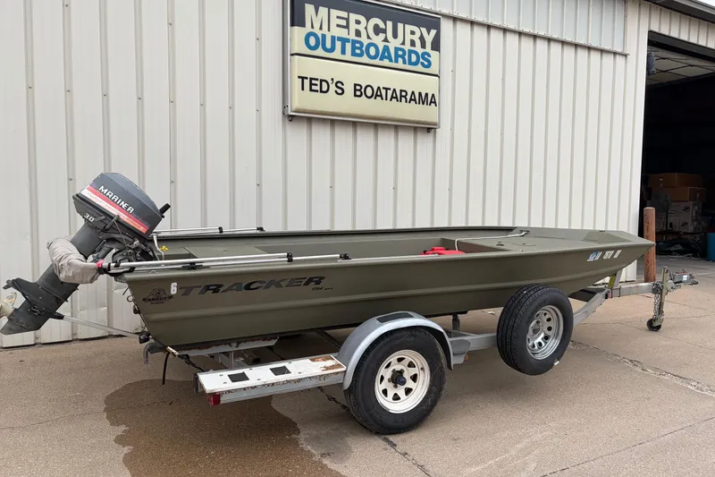 Slide: The Image of 2024 TRACKER MARINE Grizzly 1754 boat on trailer outside Ted's Boatarama. - 2