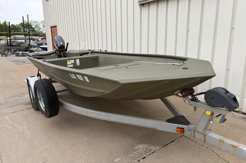 Slide: The Image of 2024 TRACKER MARINE Grizzly 1754 boat on trailer, parked beside a building. - 3