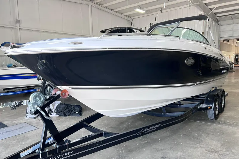 The Image of 2007 Monterey 248LS Montura Bowrider on trailer in indoor storage facility. - 0